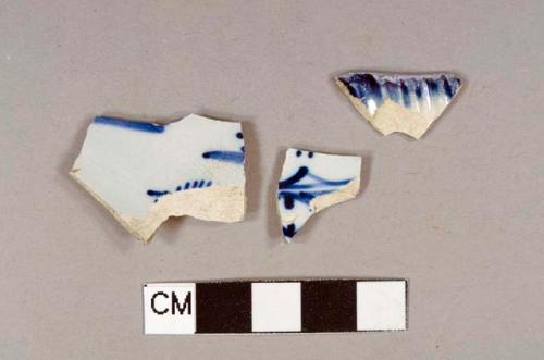 Two blue hand painted pearlware body sherds; one blue shell edge pearlware rim sherd