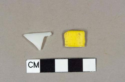 Curved milk glass rim fragment; yellow plastic threaded cap fragment