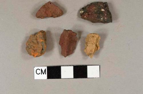 Four brick fragments; one redware body sherd missing surface on both sides