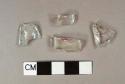 Two fragments of molded colorless bottle glass; one fragment of colorless bottle glass; one fragment of aqua bottle glass