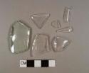One aqua bottle glass fragment; four colorless bottle glass fragments; one colorless curved glass rim fragment; one colorless bottle glass fragment with embossed "T"