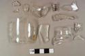 Seven colorless bottle glass fragments; one colorless bottle glass fragment with embossed letters; four molded colorless bottle glass fragments; one molded colorless bottle glass fragment with partial neck and mold seam