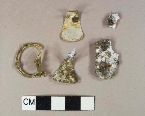 Three white metal pop-top fragments; two unidentified white metal fragments