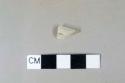 Whiteware rim fragment, burned, white/gray paste, lead glaze, undecorated