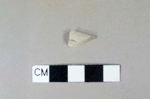 Whiteware rim fragment, burned, white/gray paste, lead glaze, undecorated