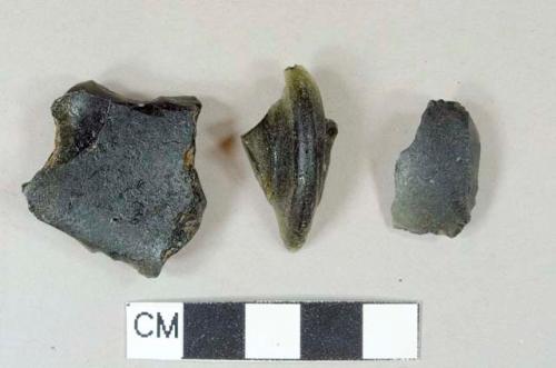 Dark olive green vessel glass, likely wine bottle, body and rim fragments