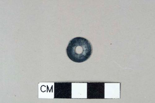 Black plastic disc, possible button back, .5cm diameter hole through center