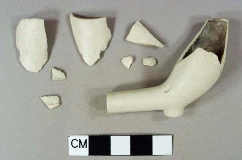 Light buff kaolin pipe bowl fragments, all crossmend, undecorated, interior of bowl burned, 6/64" diameter bore