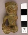 Seated male figure of green jadite Cap with chin strap
