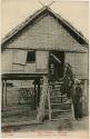 Three people in front of a house