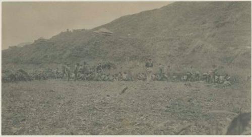 Group of people clearing the ground for a government building