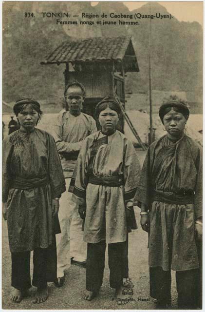 Four women standing in front of a structure