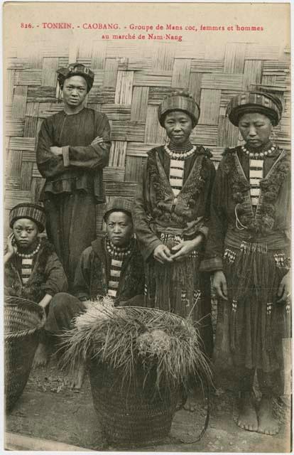 Group standing in front of a wall made of woven fiber