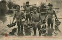 Group of men standing in water