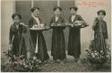 Group of women standing and holding baskets of tobacco