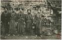 Group of women standing in front of a structure