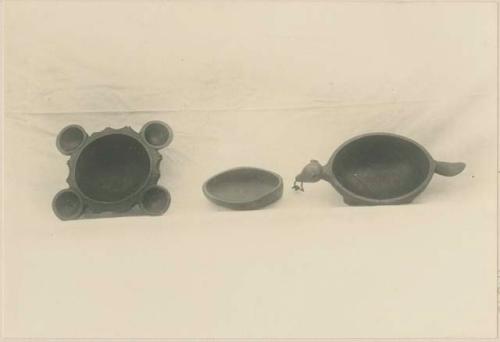 Three small carved wooden bowls, top