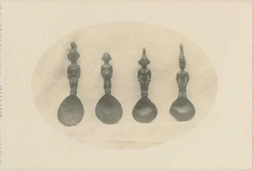 Four carved wooden spoons