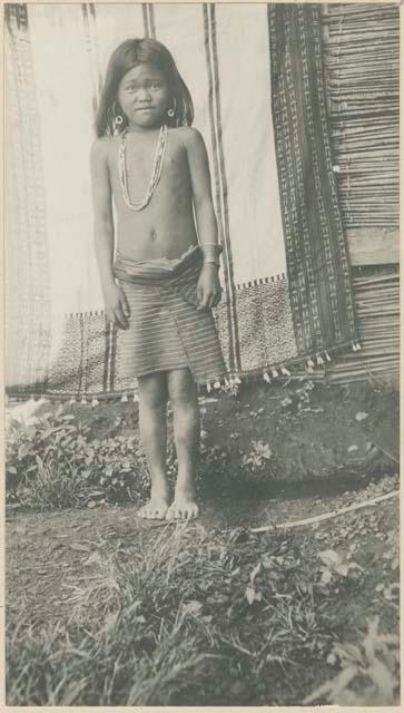 Girl standing in front of a blanket