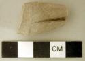 Ground stone fragment with three worked grooves, possible effigy fragment