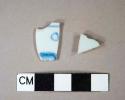 One undecorated porcelain body sherd; one blue handpainted porcelain rim sherd