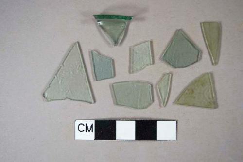 Eight fragments of aqua flat glass; one rim fragment of aqua bottle glass