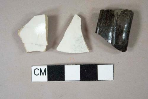 Two white stoneware body sherds; one lead glazed redware handle sherd