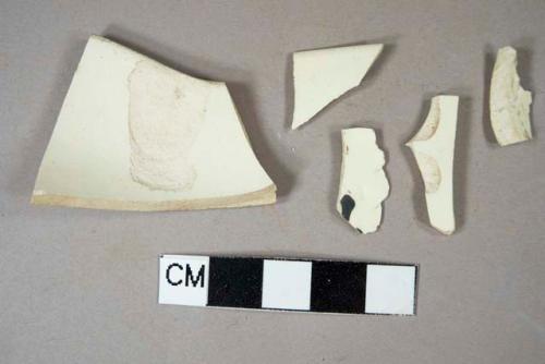 Two creamware rim sherds; two creamware body sherds; one black handpainted overglaze creamware body sherd