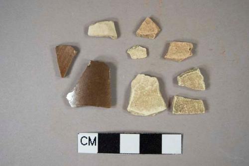 Two Nottingham stoneware body sherds; six tin glaze body sherds, missing glaze, two sherds crossmend; one pipe bowl fragment