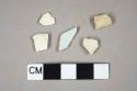 One pipe bowl fragment; one pipe stem fragment; one pearlware body sherd; two creamware body sherds, one molded