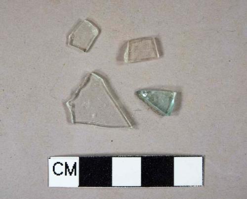 2 colorless flat glass fragments, 1 light aqua flat glass fragment, 1 colorless vessel glass body fragment