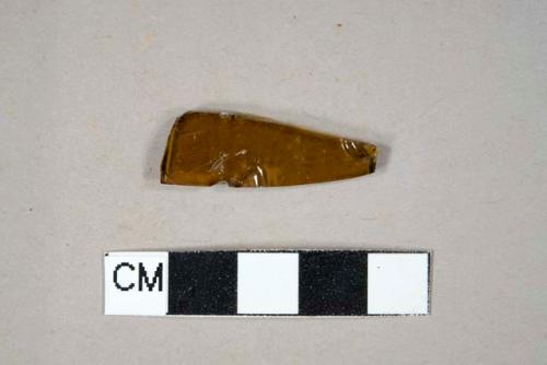 Glass, amber bottle glass fragment with embossed letters