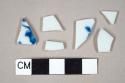 Two undecorated porcelain body sherds; two undecorated porcelain rim sherds; one blue hand painted porcelain body sherd; one blue hand painted porcelain rim sherd