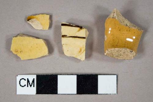 Three Staffordshire slipware body sherds; one Staffordshire slipware handle sherd