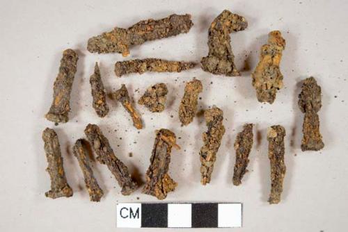 Ferrous metal nail fragments, heavily corroded, most square cut