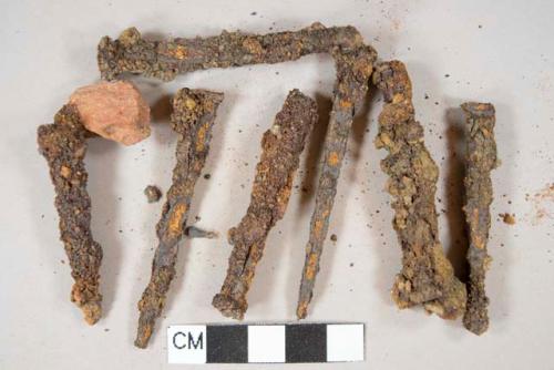 Ferrous metal nail fragments, ferrous metal screw, all heavily corroded