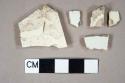 Three undecorated creamware body sherds; two undecorated whiteware body sherds