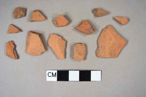 Undecorated, unglazed redware body sherds; one crossmends with one brown lead glazed redware body sherd