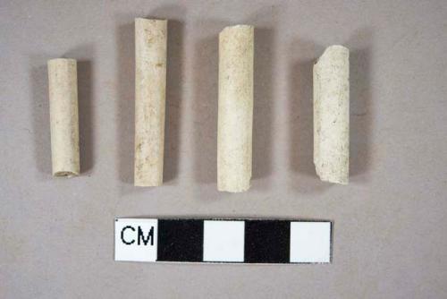 Unsmoked, undecorated pipe stem fragments, 5/64" bore diameter; two fragments crossmend