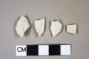 Smoked pipe bowl fragments, three undecorated, one with possible "TD" cartouche; three fragments crossmend