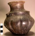 Pottery pytomorphic vase, with blackish polished coat of paint