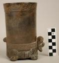 Cylindrical vessel with plastic jaguar head, tail, 4 feet and incised motifs