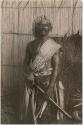 Fijian man in a studio-staged scene, holding a club