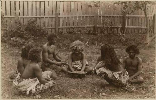 Fijians sitting outside making kava