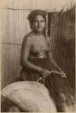 Staged portrait of woman with fishing basket