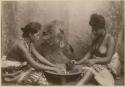 Studio portrait of two women making kava