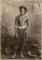 Fijian man in a studio-staged scene, holding a club