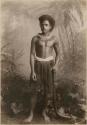 Fijian man in a studio-staged scene, holding a club