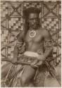 Fijian man in a studio-staged scene, holding a club