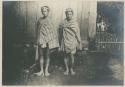 Two Igorot men wrapped in their blankets